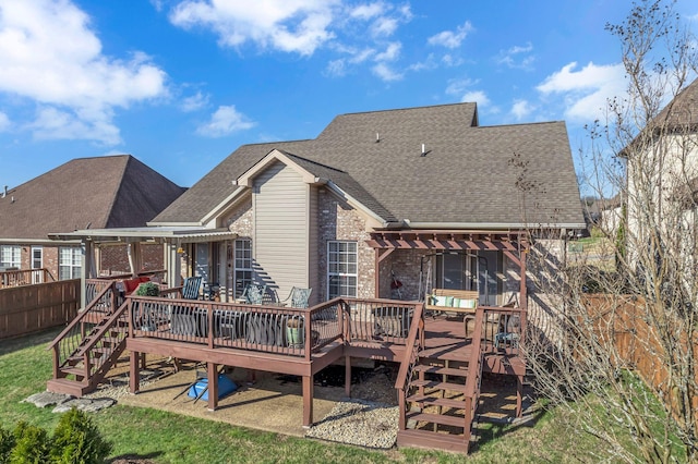 rear view of house with a pergola and a wooden deck