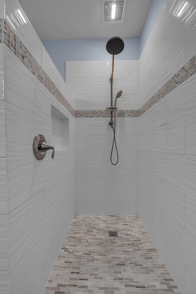 bathroom with tiled shower