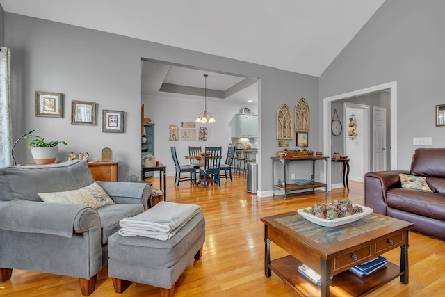 living room with a chandelier and light wood-type flooring