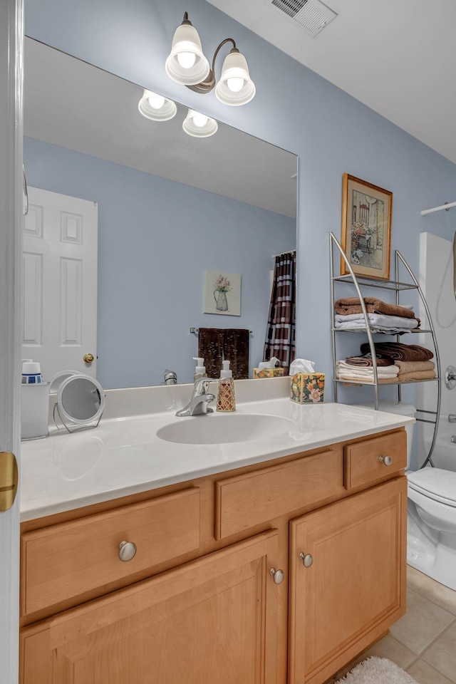 full bathroom with tile patterned floors, vanity, toilet, and shower / tub combo