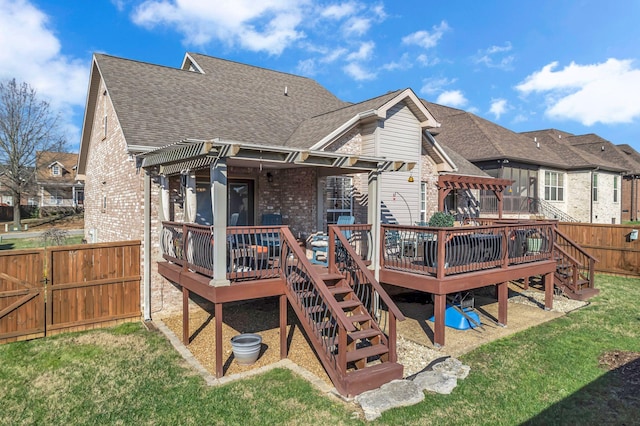 back of house featuring a pergola, a yard, and a deck