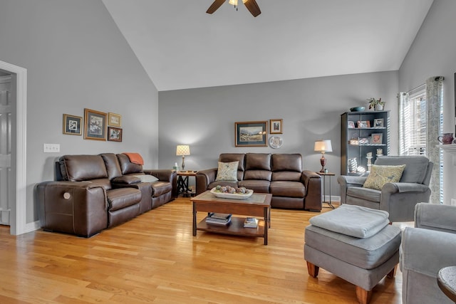 living room with light hardwood / wood-style floors, high vaulted ceiling, and ceiling fan