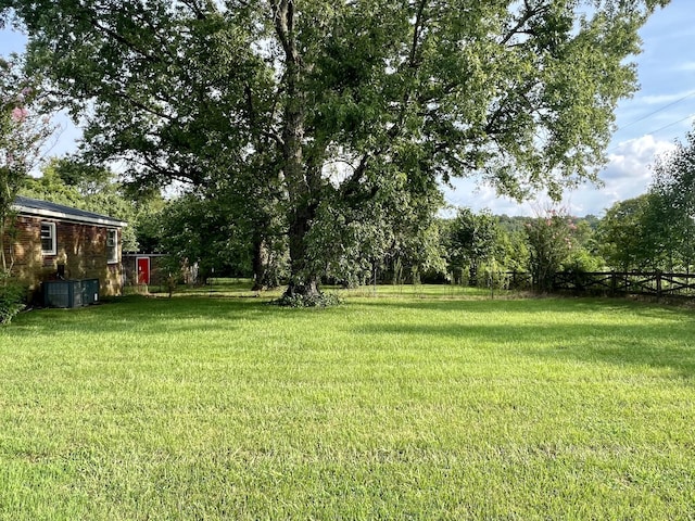 view of yard with central air condition unit