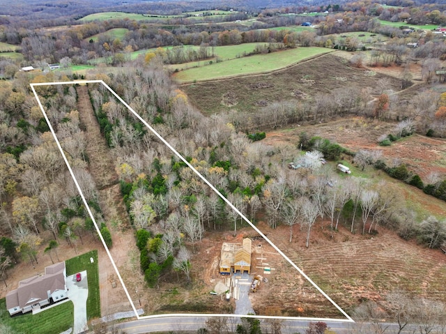 birds eye view of property with a rural view