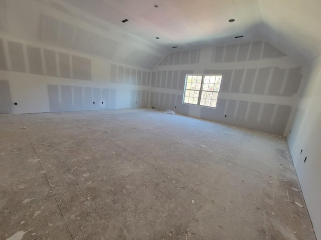 spare room with vaulted ceiling