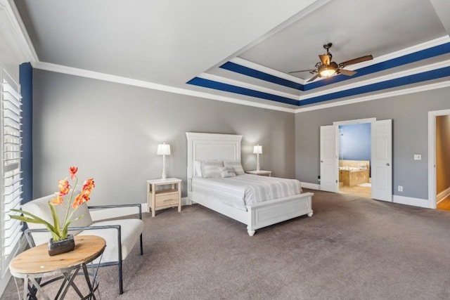 bedroom featuring ornamental molding, connected bathroom, a tray ceiling, ceiling fan, and carpet floors