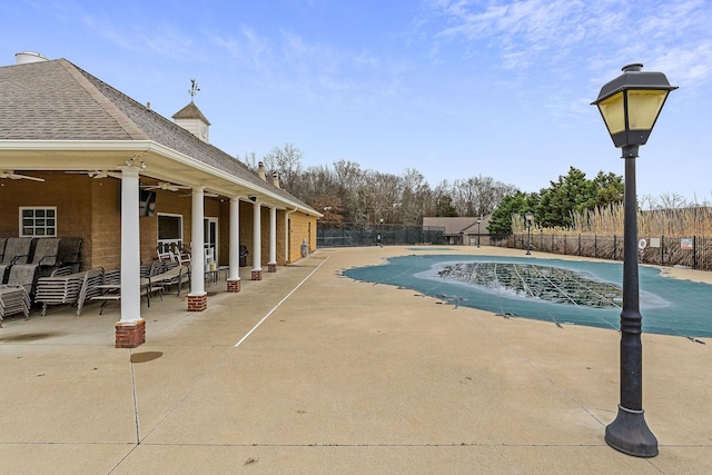 view of pool with a patio and ceiling fan