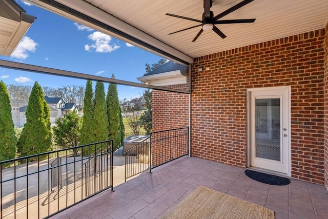 view of patio featuring ceiling fan and a balcony