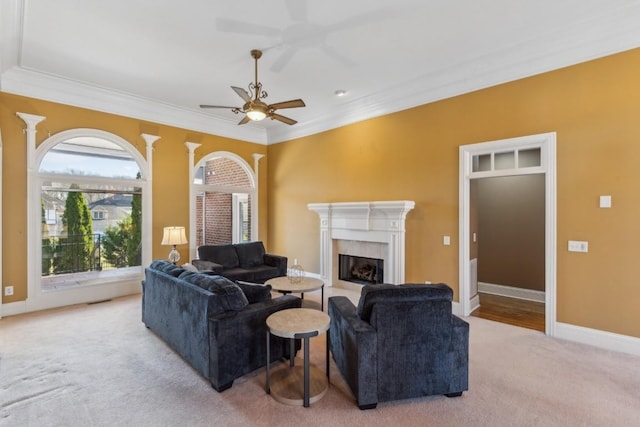 living room featuring carpet flooring, ceiling fan, and ornamental molding