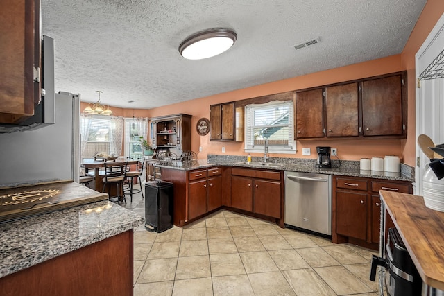 kitchen featuring kitchen peninsula, a wealth of natural light, sink, and stainless steel dishwasher