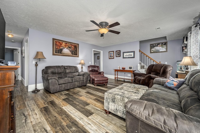 living room with a textured ceiling, hardwood / wood-style flooring, and ceiling fan