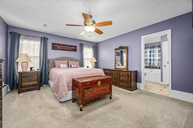 carpeted bedroom featuring ceiling fan, a textured ceiling, and connected bathroom