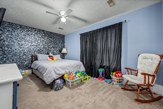 carpeted bedroom with ceiling fan and a textured ceiling