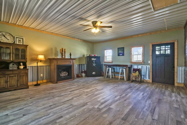 unfurnished living room with dark hardwood / wood-style flooring and ceiling fan