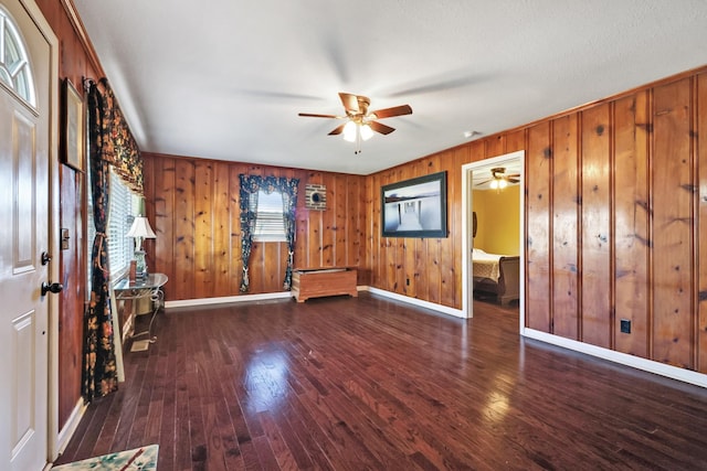 interior space featuring ceiling fan and dark wood-type flooring