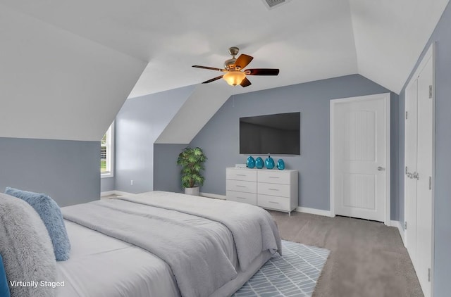 carpeted bedroom with vaulted ceiling and ceiling fan