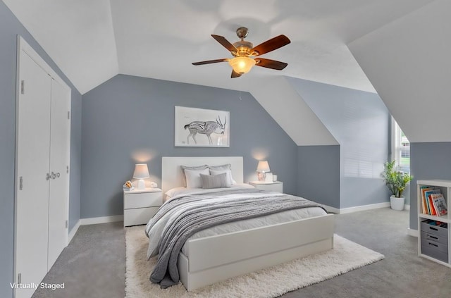 carpeted bedroom with a closet, ceiling fan, and lofted ceiling