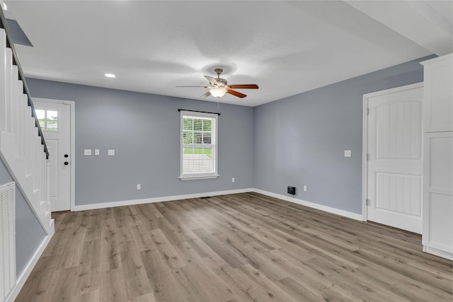 empty room with ceiling fan, a healthy amount of sunlight, and light hardwood / wood-style floors