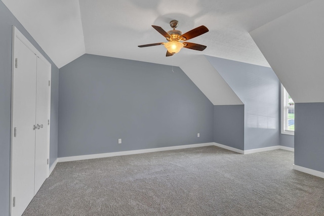 bonus room with ceiling fan, lofted ceiling, and light carpet