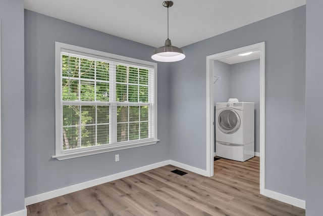 interior space with washer / dryer and light wood-type flooring