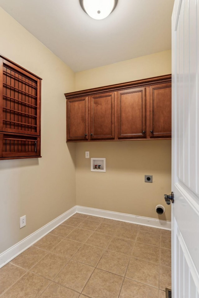 laundry room with cabinets, hookup for a washing machine, hookup for an electric dryer, and light tile patterned flooring