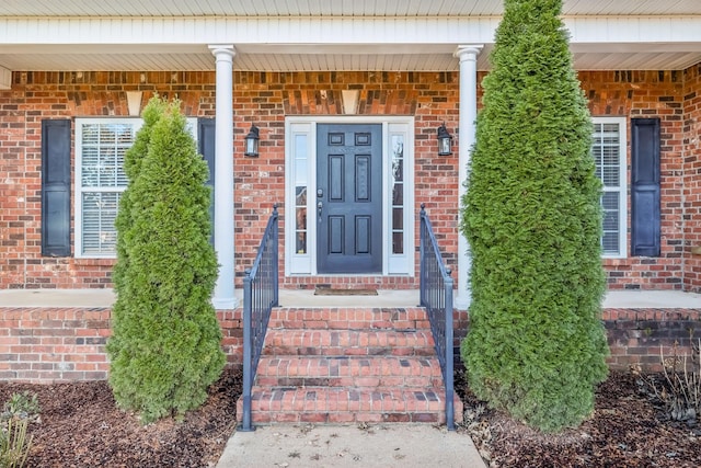 view of exterior entry featuring a porch