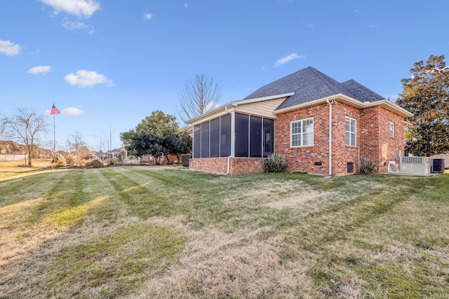 view of home's exterior featuring a yard and a sunroom