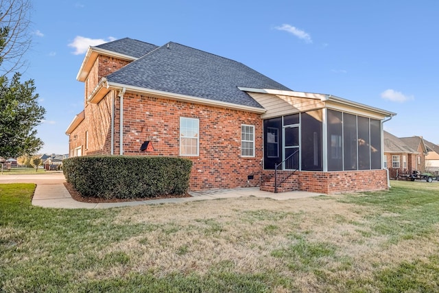 back of house featuring a sunroom and a lawn