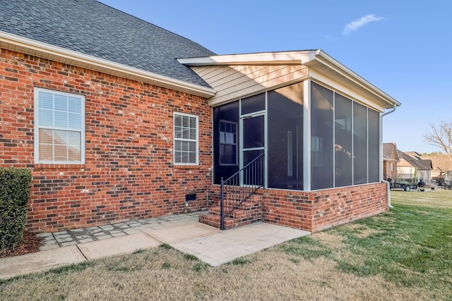 back of house featuring a yard and a sunroom