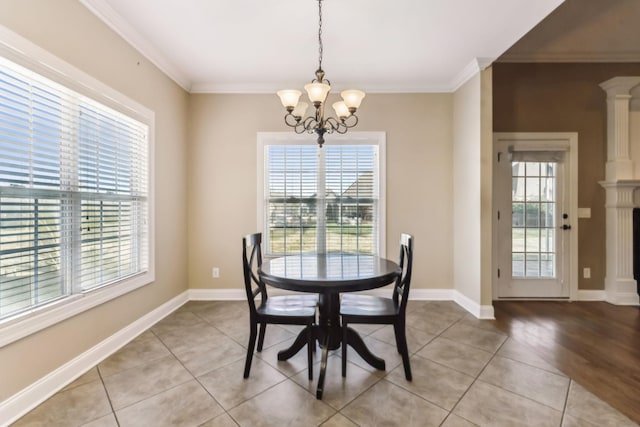 tiled dining space featuring an inviting chandelier and crown molding