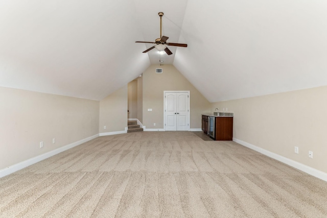 bonus room with lofted ceiling, light colored carpet, and ceiling fan