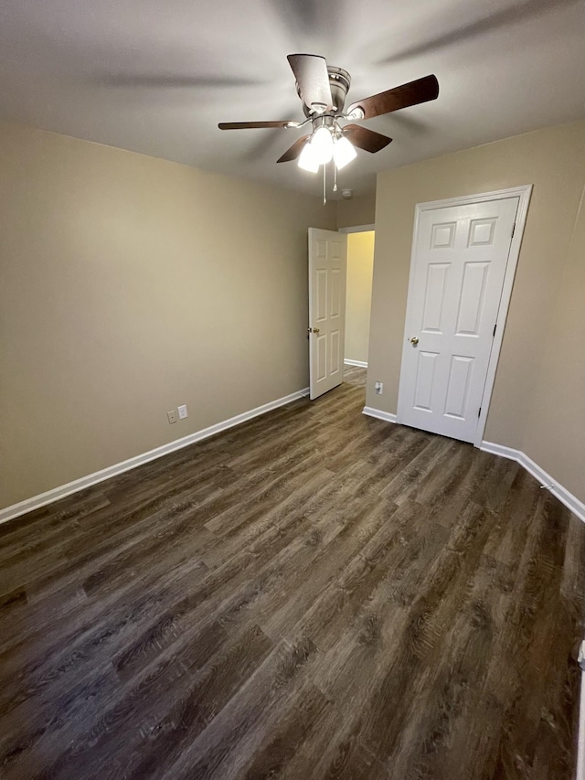 unfurnished bedroom with ceiling fan and dark hardwood / wood-style floors