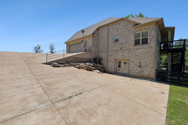 view of home's exterior with a wooden deck and a garage