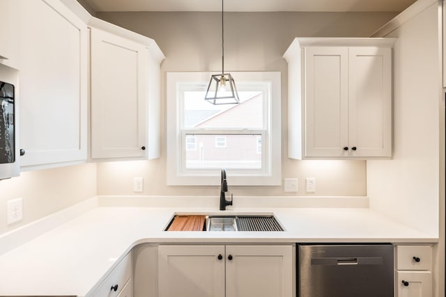 kitchen featuring decorative light fixtures, white cabinetry, and sink