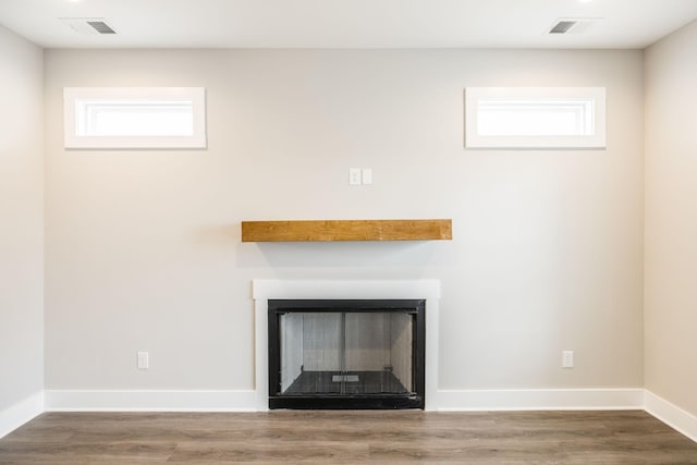 interior details with a fireplace and hardwood / wood-style flooring