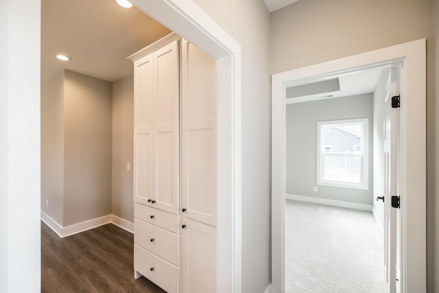 corridor with dark colored carpet