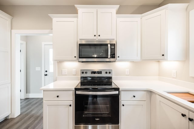 kitchen featuring white cabinets, stainless steel appliances, and light hardwood / wood-style flooring