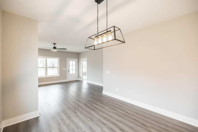 interior space with ceiling fan and wood-type flooring