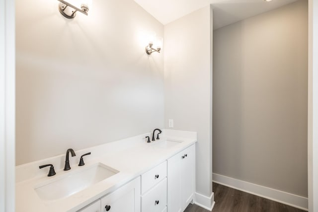 bathroom with hardwood / wood-style floors and vanity