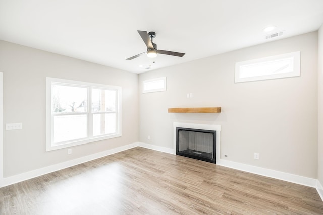 unfurnished living room with ceiling fan and light hardwood / wood-style floors