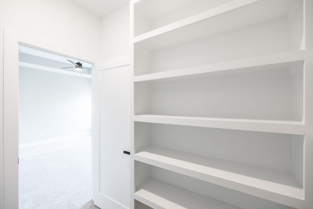 spacious closet with carpet and ceiling fan