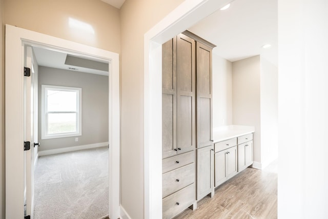 hallway with light colored carpet