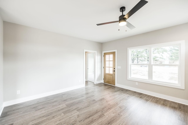 empty room featuring ceiling fan and hardwood / wood-style floors