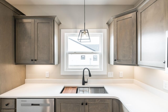 kitchen with dishwasher, sink, and hanging light fixtures