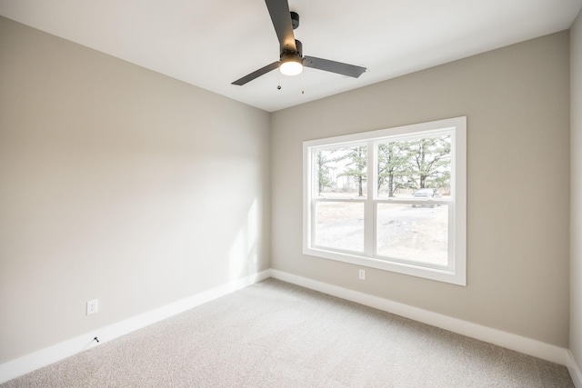 spare room featuring carpet and ceiling fan