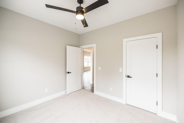 unfurnished bedroom with light carpet and ceiling fan