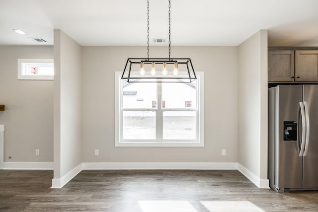 unfurnished dining area featuring dark wood-type flooring