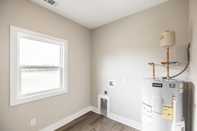 laundry room featuring electric dryer hookup, electric water heater, dark wood-type flooring, and washer hookup