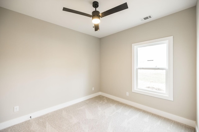 carpeted spare room with ceiling fan