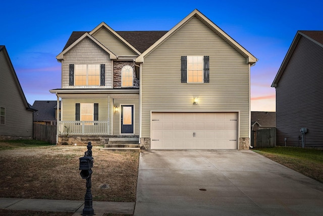 view of front of home featuring covered porch and a garage